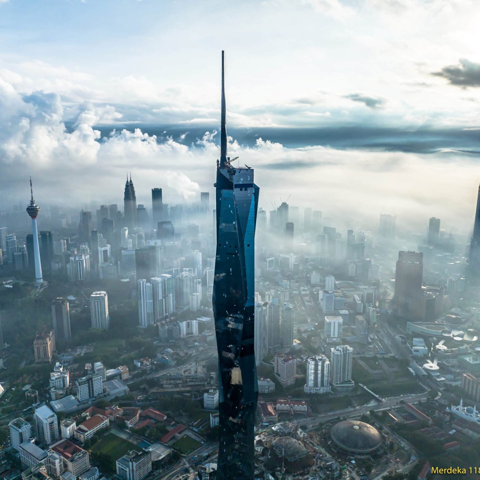 Merdeka 118 is a geometrically intricate 118 storey office and hotel tower that will be home to the headquarters for Permodalan Nasional Berhad (PNB), one of Malaysia's leading investment firms. With a completed height of more than 635 meters, PNB 118 will be the tallest building in Malaysia, and rank amongst the world's ten tallest buildings.   Merdeka 118 will feature 83 floors of premium office space, whilst the Park Hyatt luxury hotel will take up residence in the top one floors - with approximately 250 guestrooms and suites,that are designed to embrace the unparalleled sweeping views of the city skyline. The hotel will offer approximately 1,850 square meters of meeting space for conferences and events.  The megatall Merdeka 118 is pursuing a rigorous environmental program and is seeking triple platinum sustainability certification under the USGBC’s LEED program, the Malaysian Green Building Index, and the Malaysian GreenRE program.  The Merdeka at 118 retail mall connects the Merdeka 118 office tower with the accompanying smaller residential towers, and features a connection to Kuala Lumpur's public transit network via a 'Merdeka' MRT station. The 147,756 square meter mall will provide space for more than 328 stores. As a whole, the Merdeka 118 Development is one of the largest projects undertaken in Malaysia. Turner is managing construction of the tower, as well as providing project management services for the multilevel retail mall and infrastructure portions of the development.